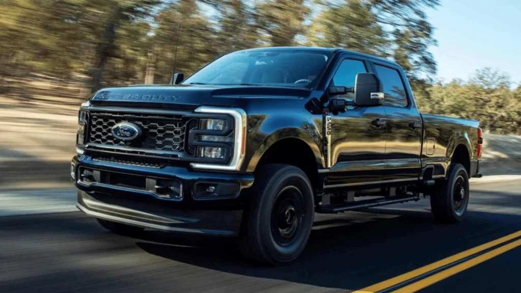 A 2025 Ford Super Duty F-350® truck driving down a road in Cleveland, OH, showcasing its powerful design and performance.
