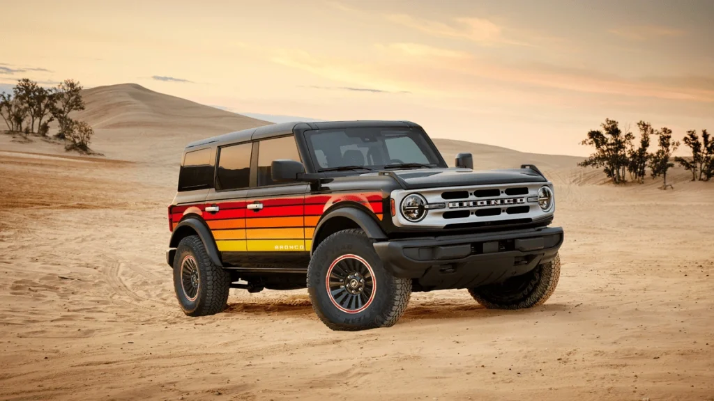2025 Ford Bronco® in desert terrain with retro graphics, ideal for blog comparison vs. Jeep Wrangler for Euclid off-road enthusiasts.