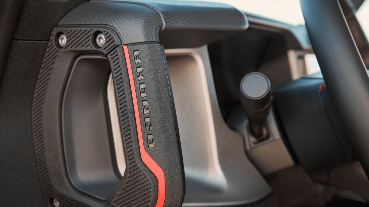 Interior grab handle detail with red accent labeled “Bronco” inside the 2025 Ford Bronco® in Euclid, OH.