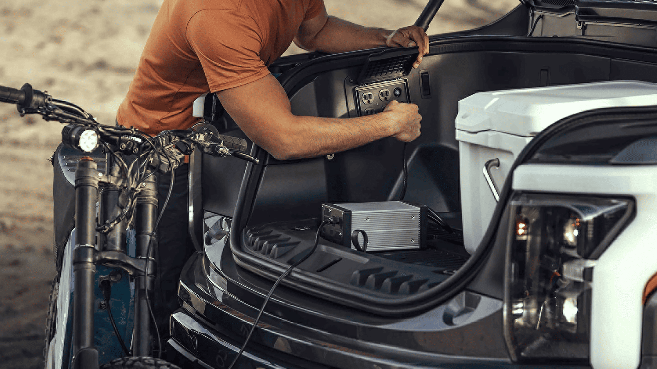 Man checking front trunk outlets of 2024 Ford F-150 Lightning in Cleveland, OH
