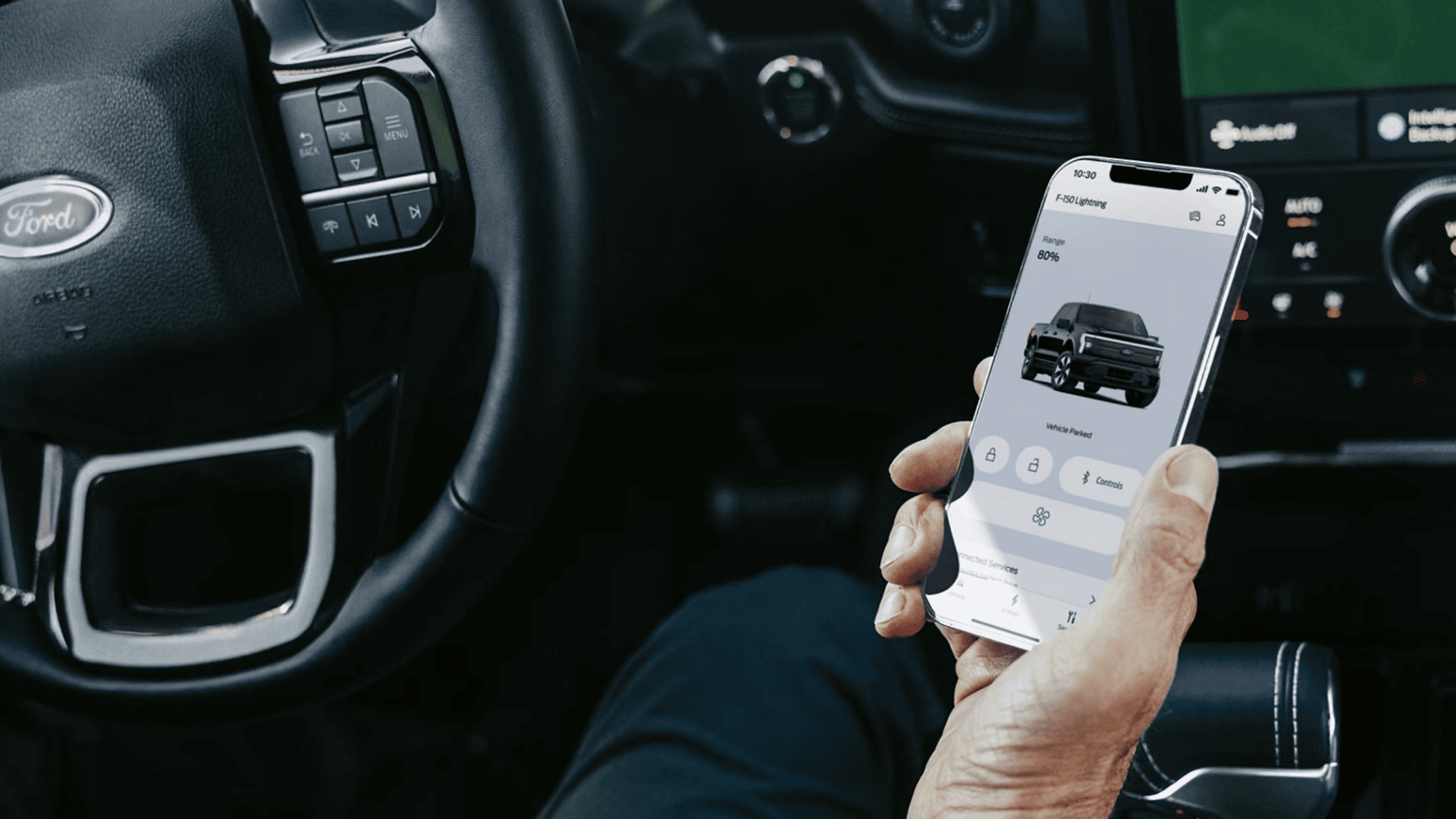 Driver using rear view camera inside 2024 Ford F-150 Lightning in Cleveland, OH