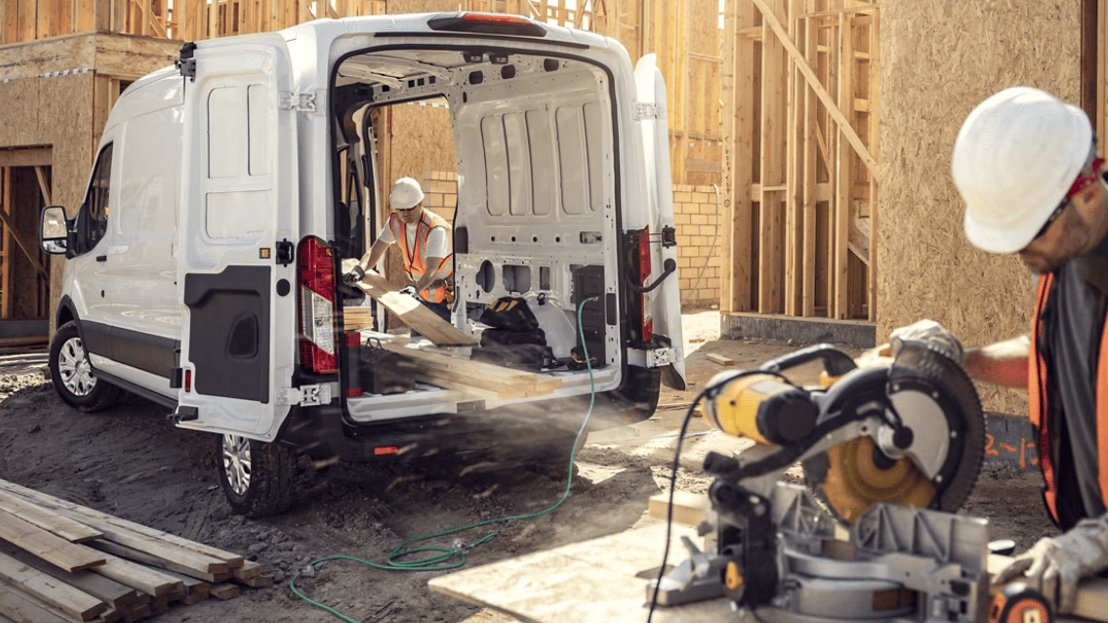 Construction workers using 2025 Ford E-Transit cargo space at a Cleveland, OH job site