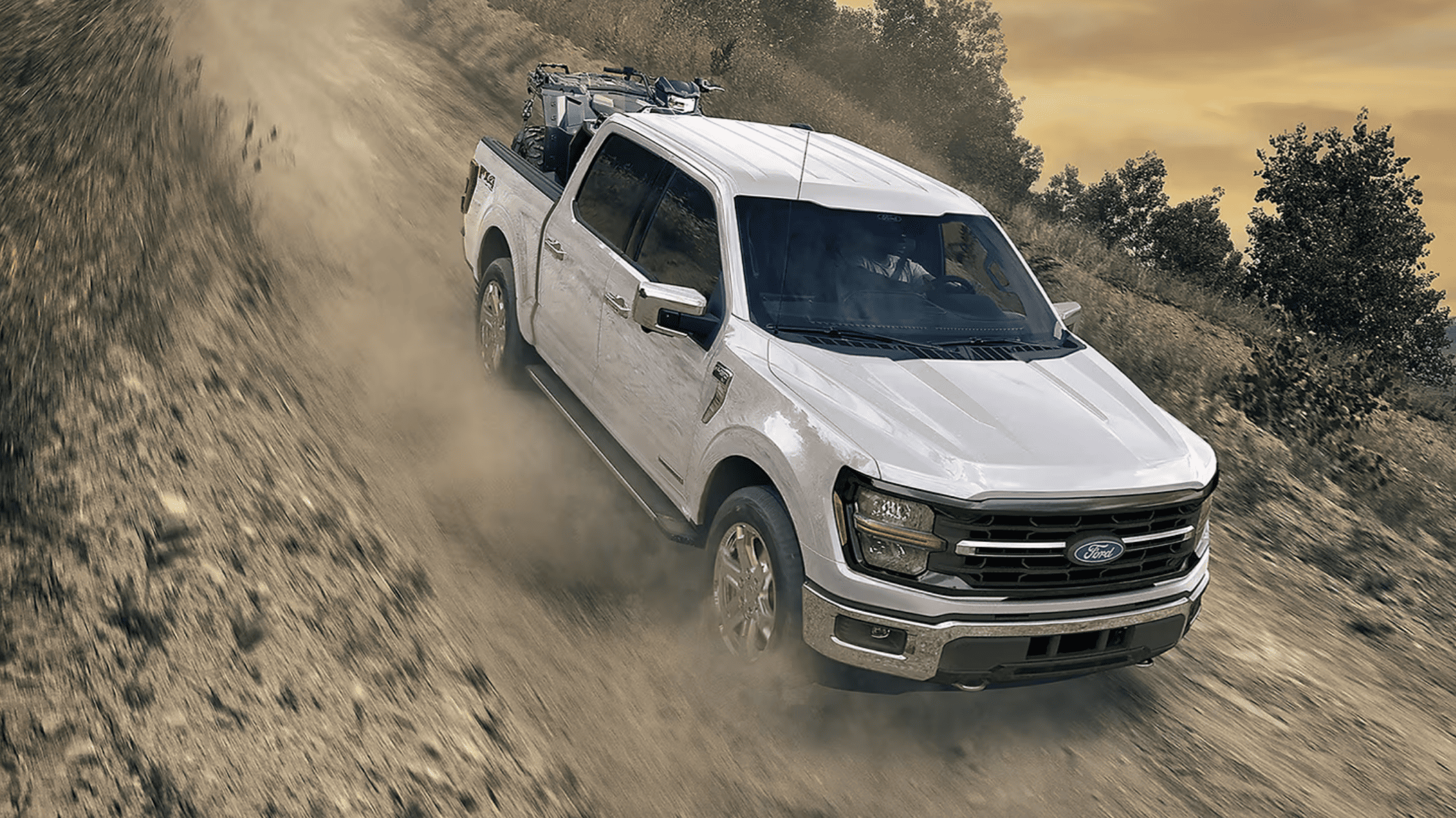 2025 Ford F-150 pickup truck hauling heavy equipment at a snowy job site in Cleveland, OH