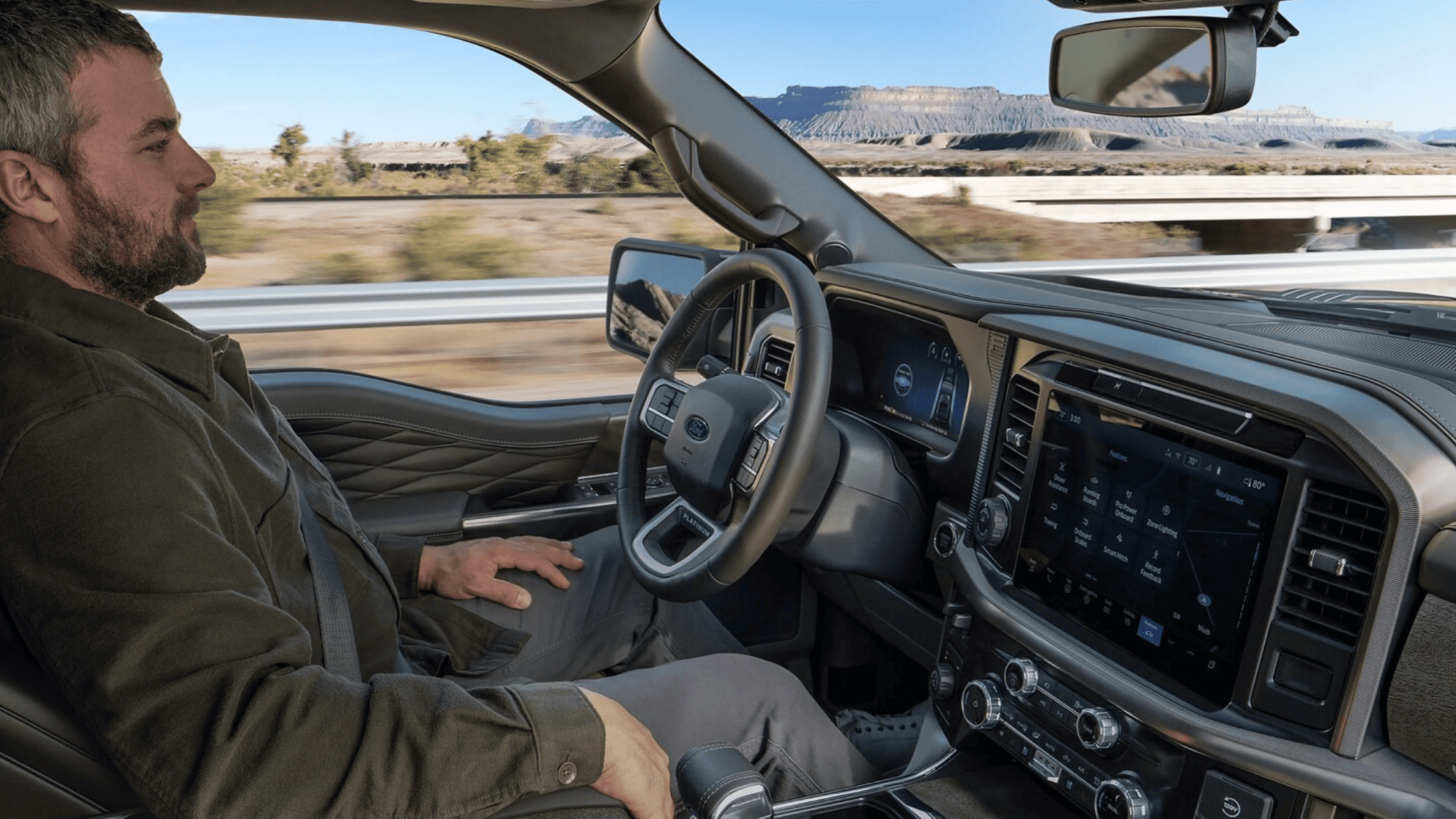 2025 Ford F-150 driving off-road on a rugged dirt trail with an ATV in the truck bed in Cleveland, OH