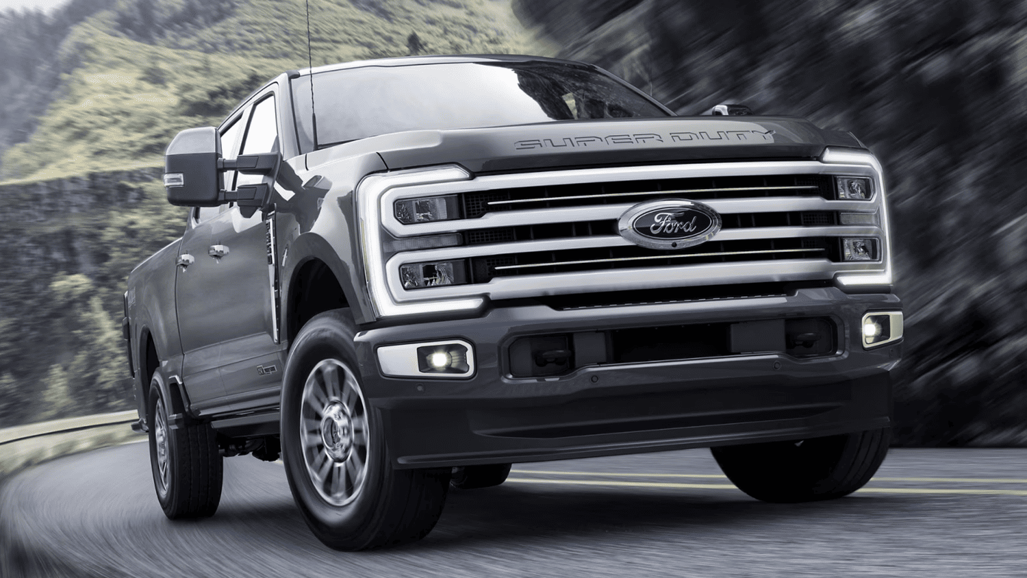 Front view of the 2025 Ford Super Duty® near Euclid, OH driving through a winding mountain road.